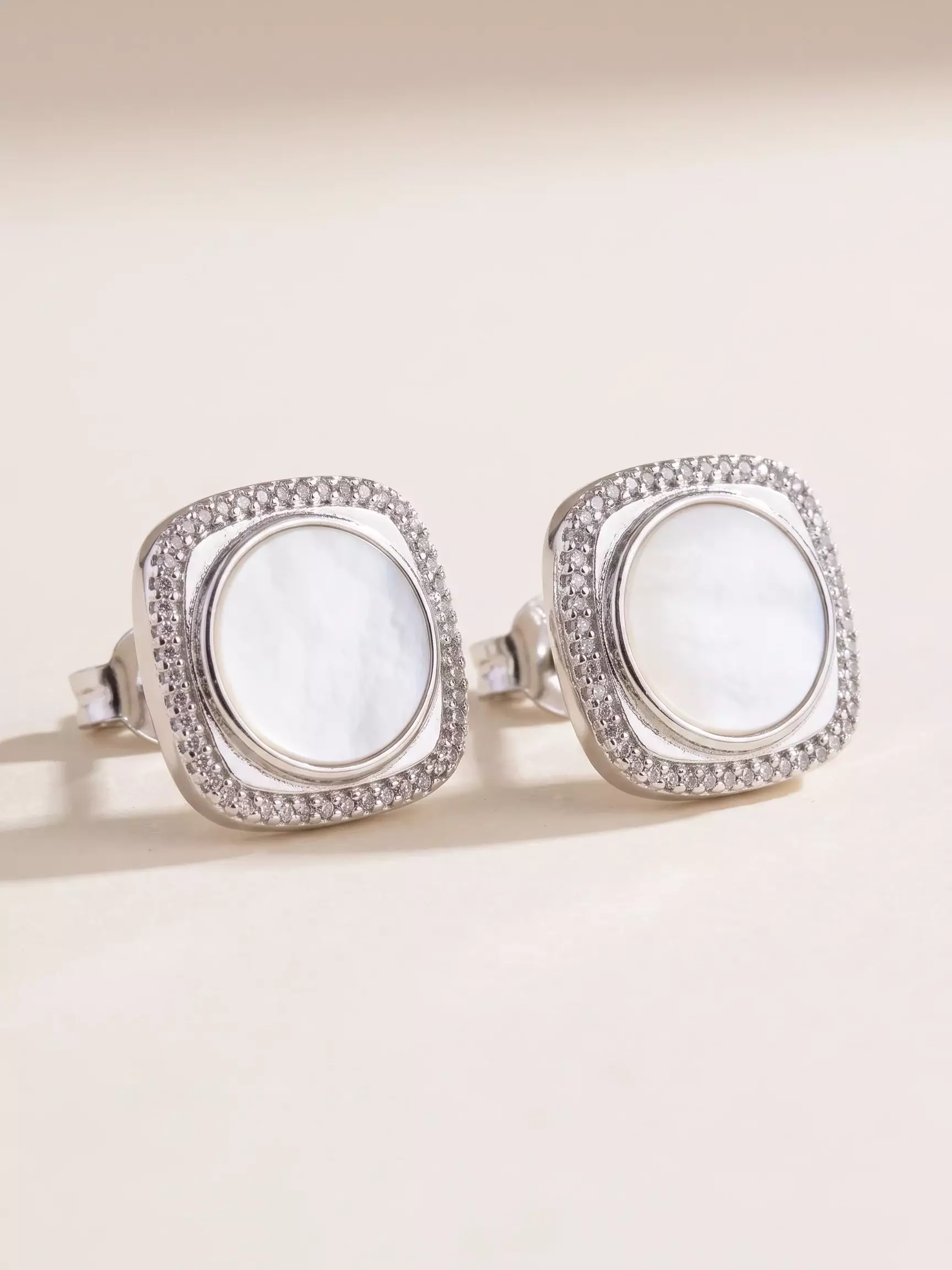 Square beaded resin earrings with silver-tone finish, pair laid flat, close-up view