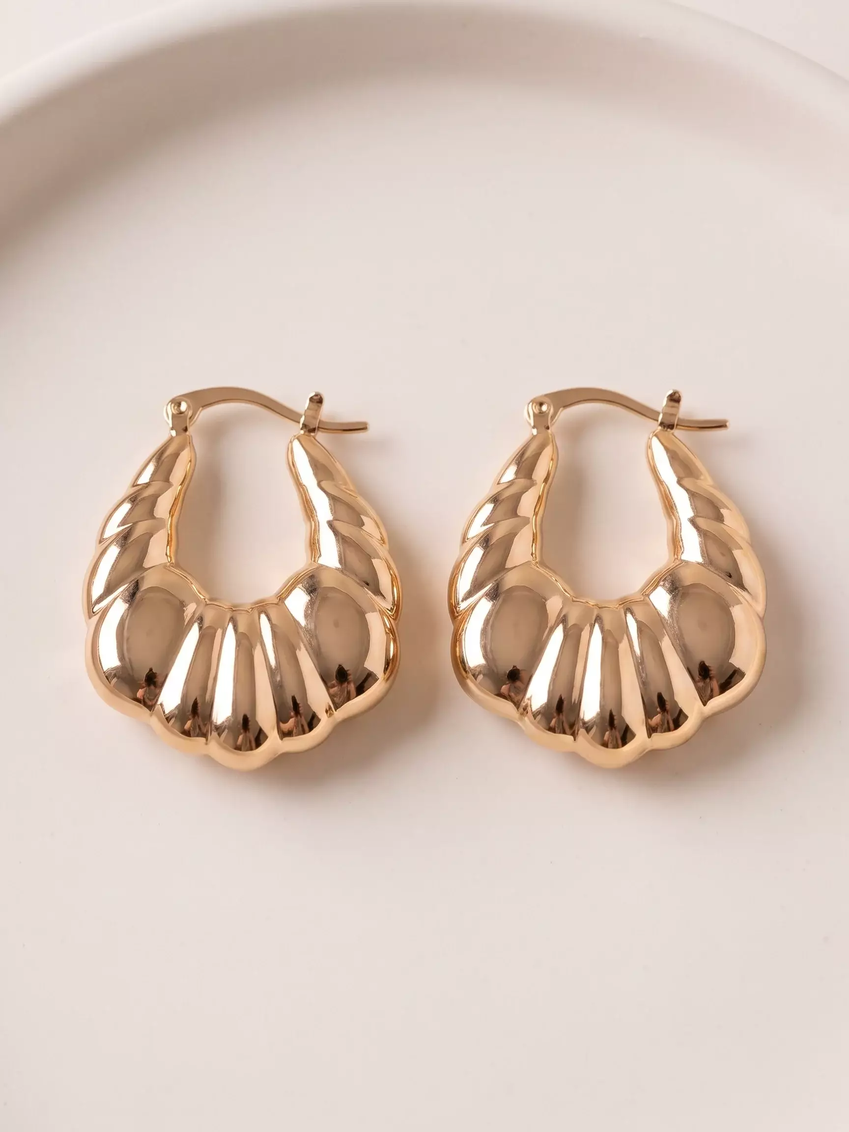 Crescent hoop earrings, pair displayed, close-up view