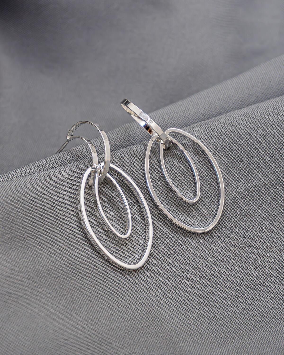 Silver-Tone Earrings, Flat Half-Hoop and Two Interlocking Openwork Ovals – On Grey Fabric