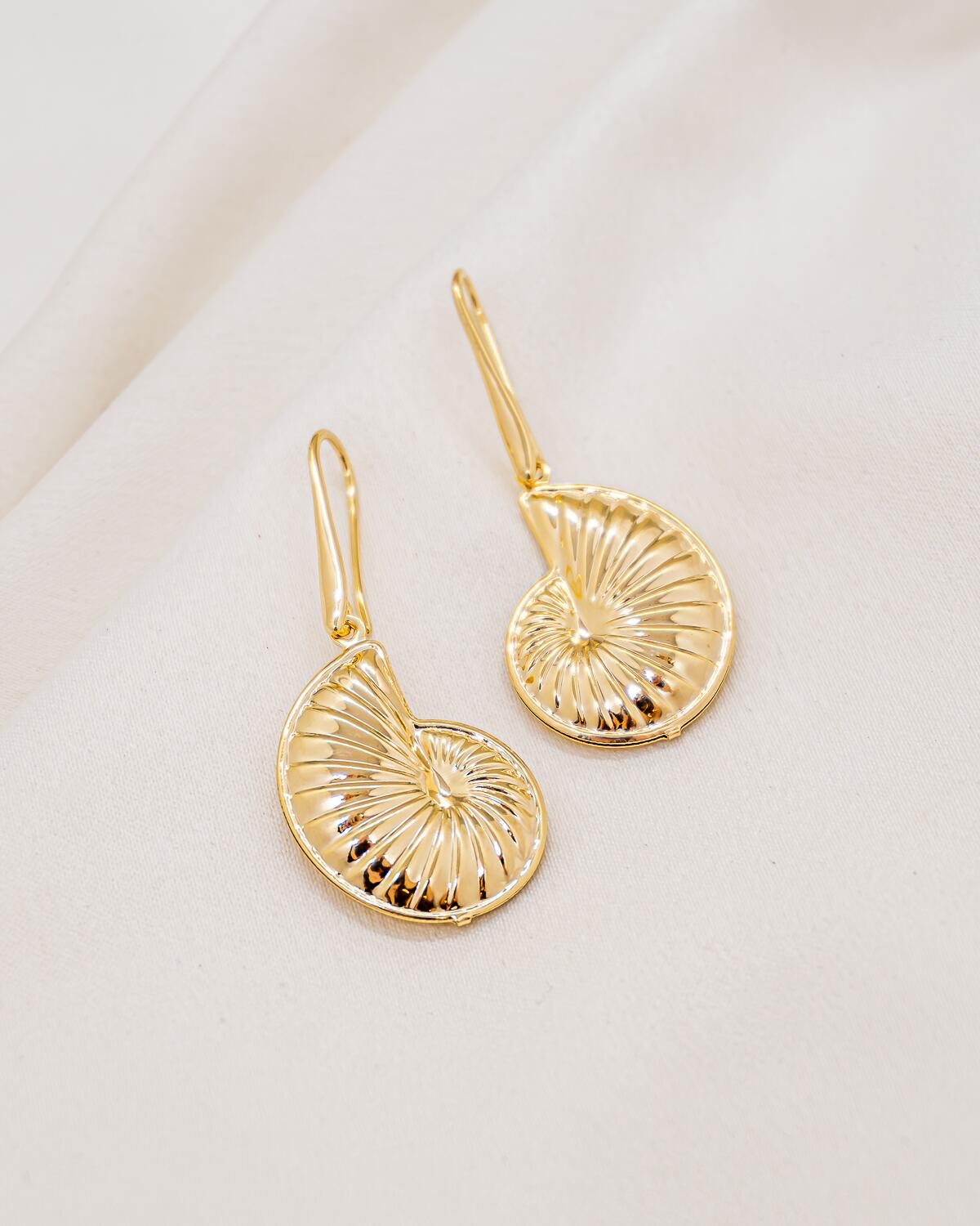 Pair of golden hook earrings, ridged spiral shell