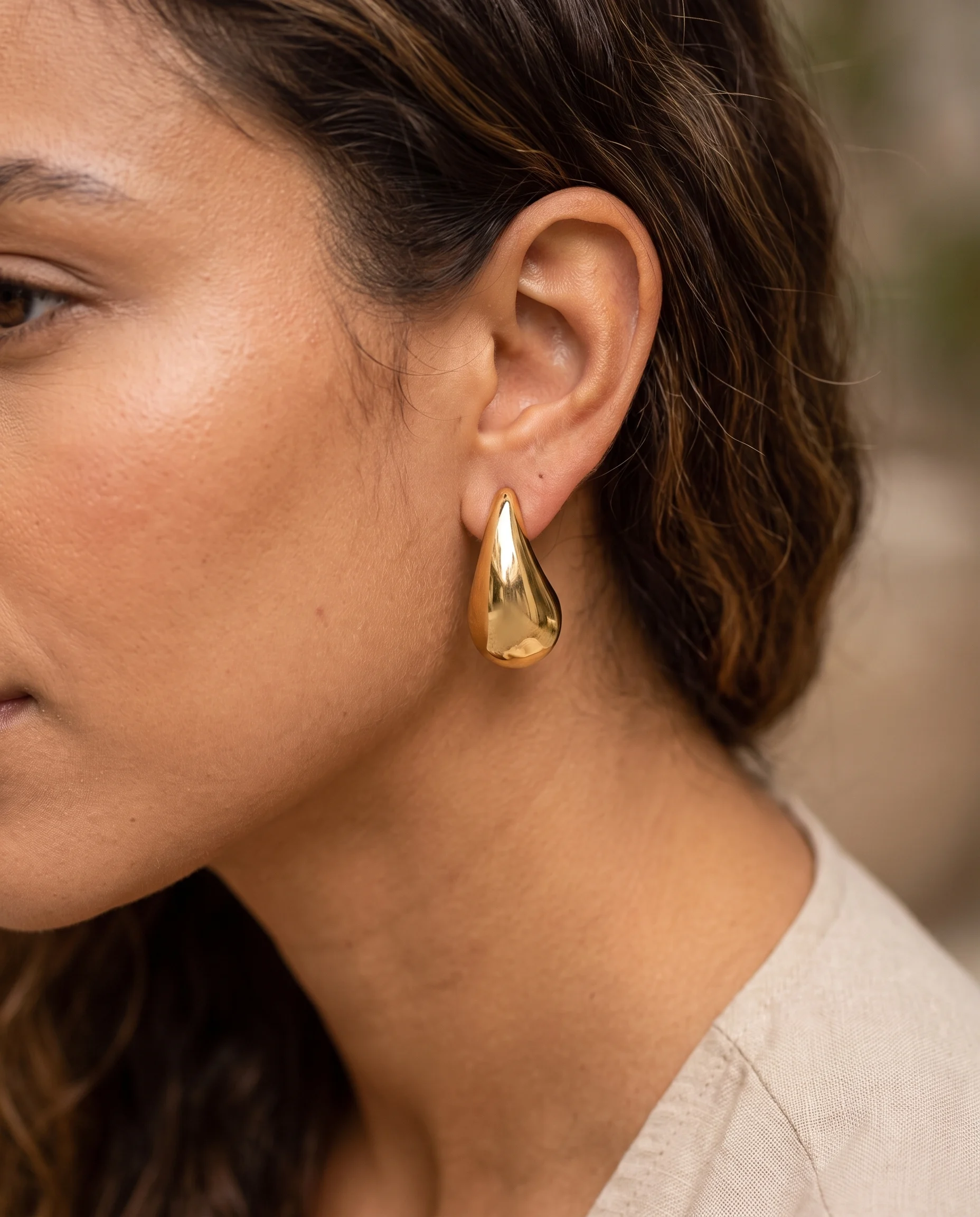 Bold 4.1cm teardrop earrings, worn, close-up view