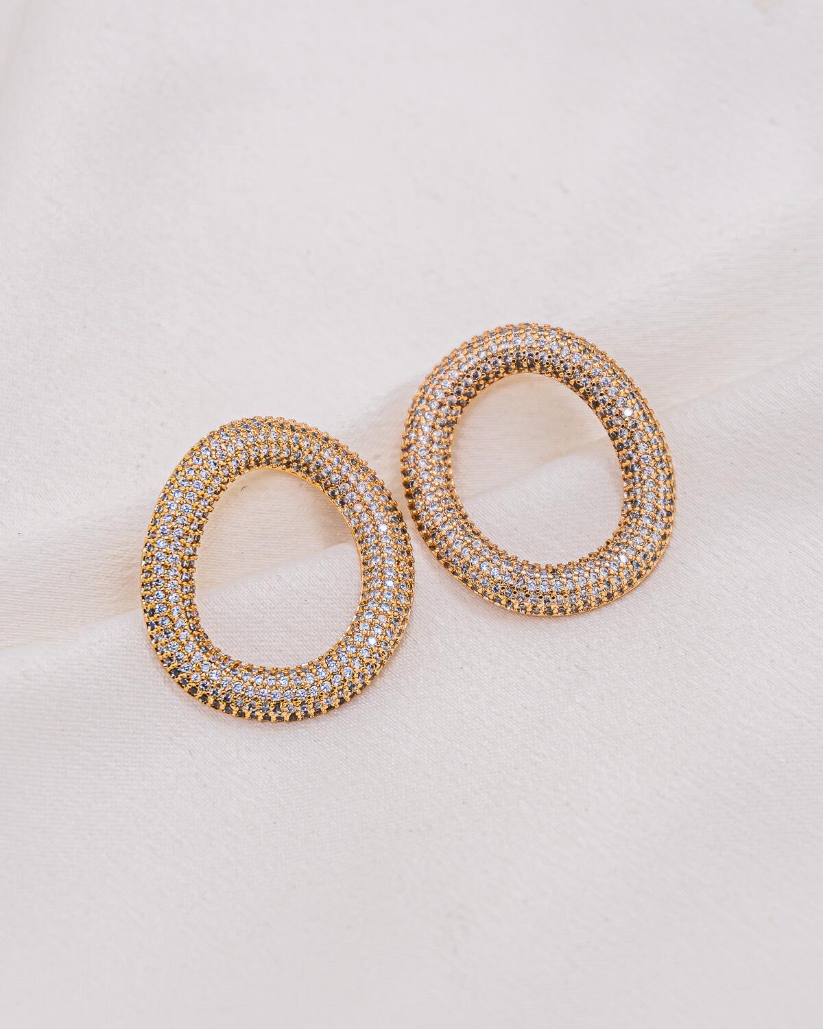 Pair of gold openwork oval earrings, fully pavé-set with small clear stones