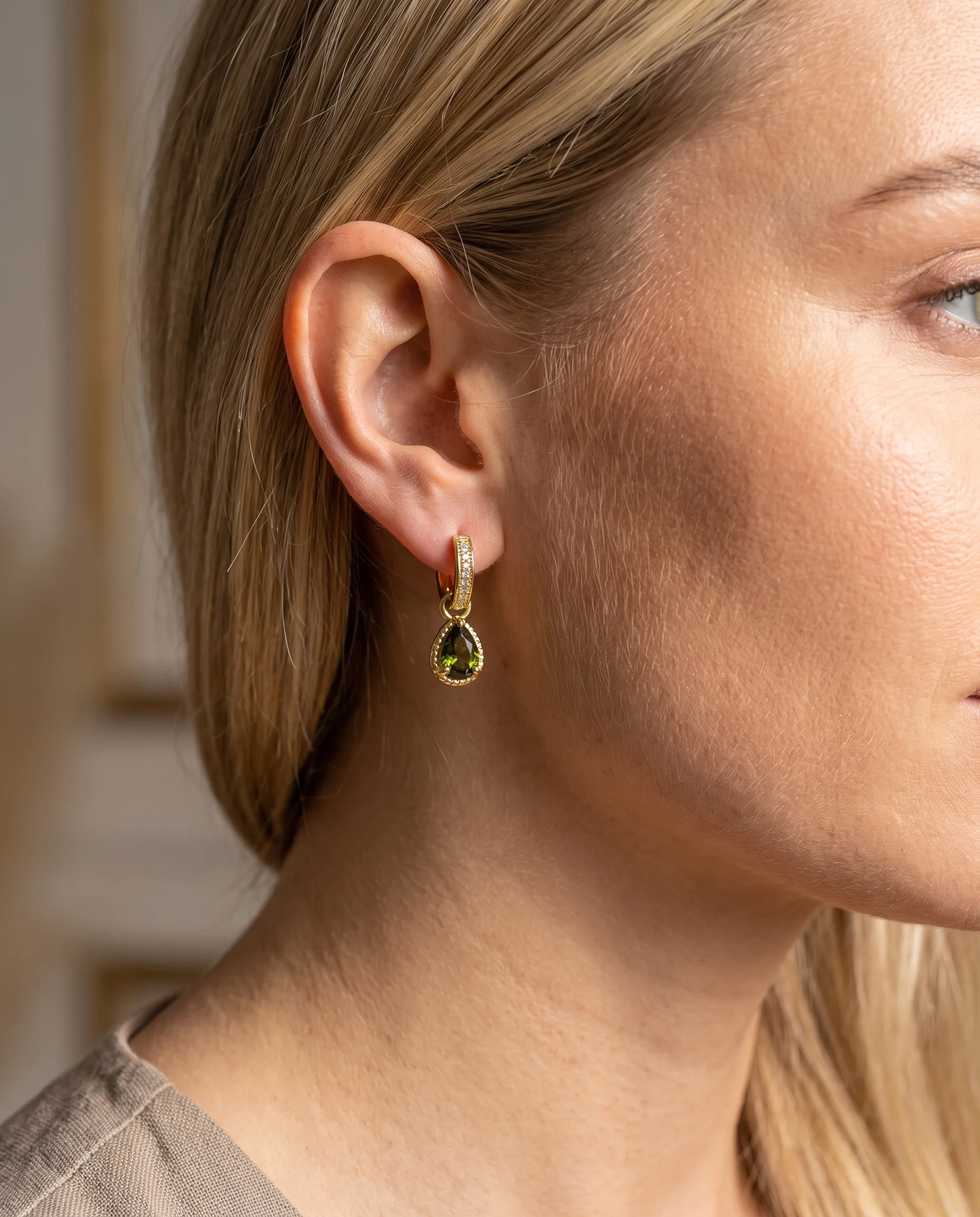 Small set hoop earrings, moss green teardrop zircon, worn, close-up view