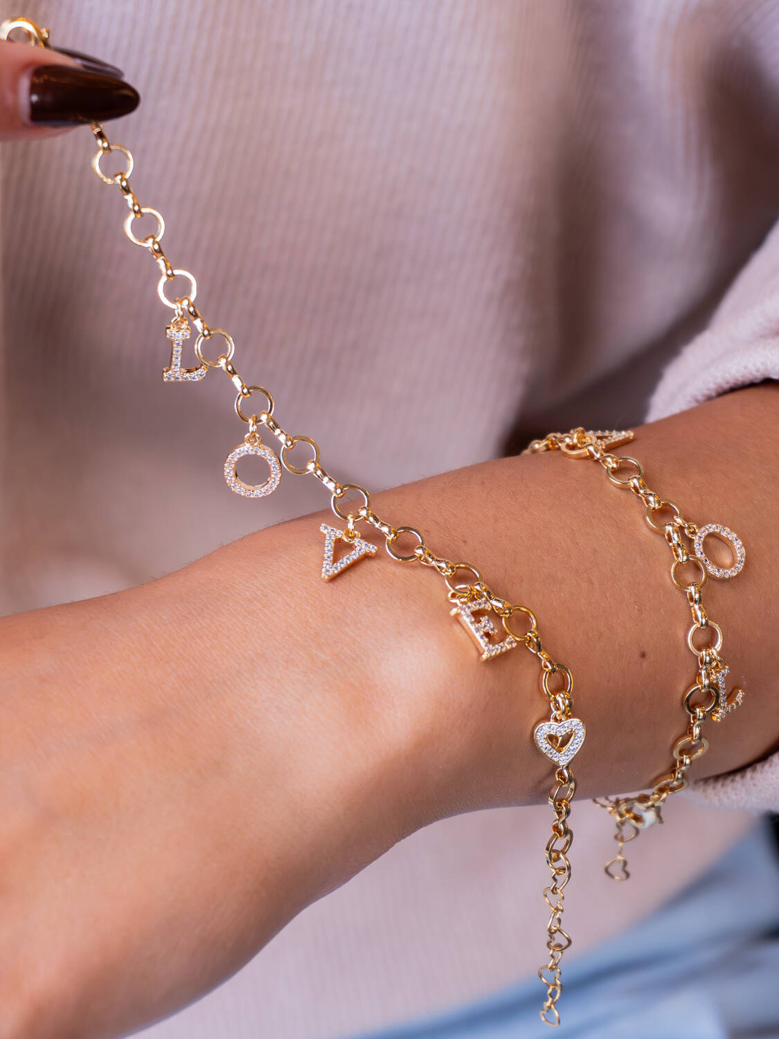 Bracelet doré à anneaux ronds avec lettres L O V E pavées de pierres claires