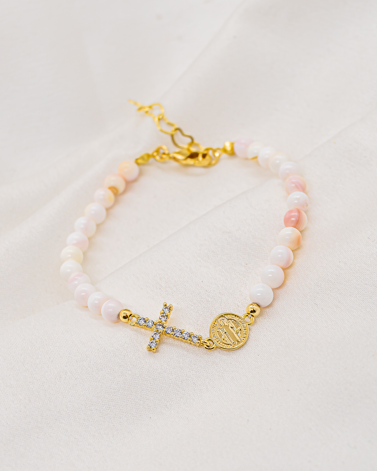 Pink and white mother-of-pearl beaded bracelet with gold pavé-set cross and round medallion