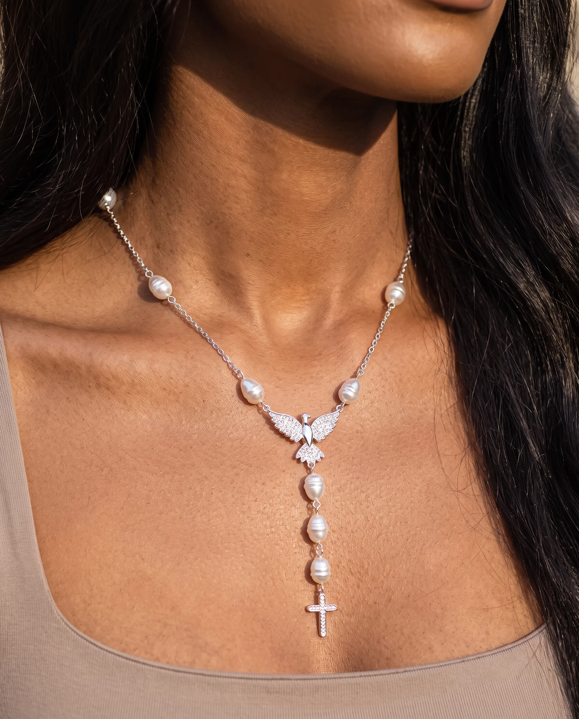 Silver-tone rosary necklace with baroque pearls, pavé-set dove and small cross, close-up view