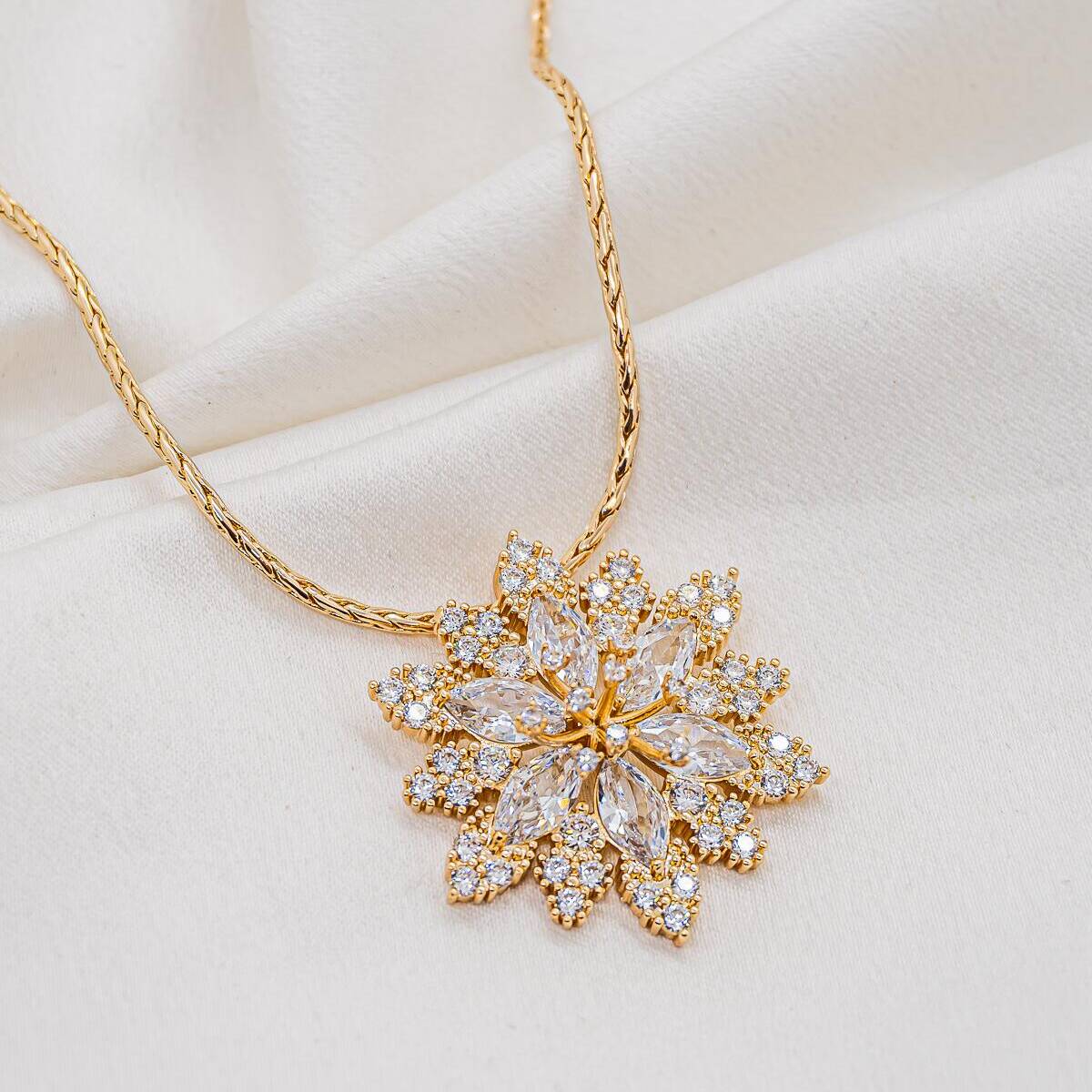 Gold necklace with large flower pendant in marquise-cut zircons, framed by small round stones
