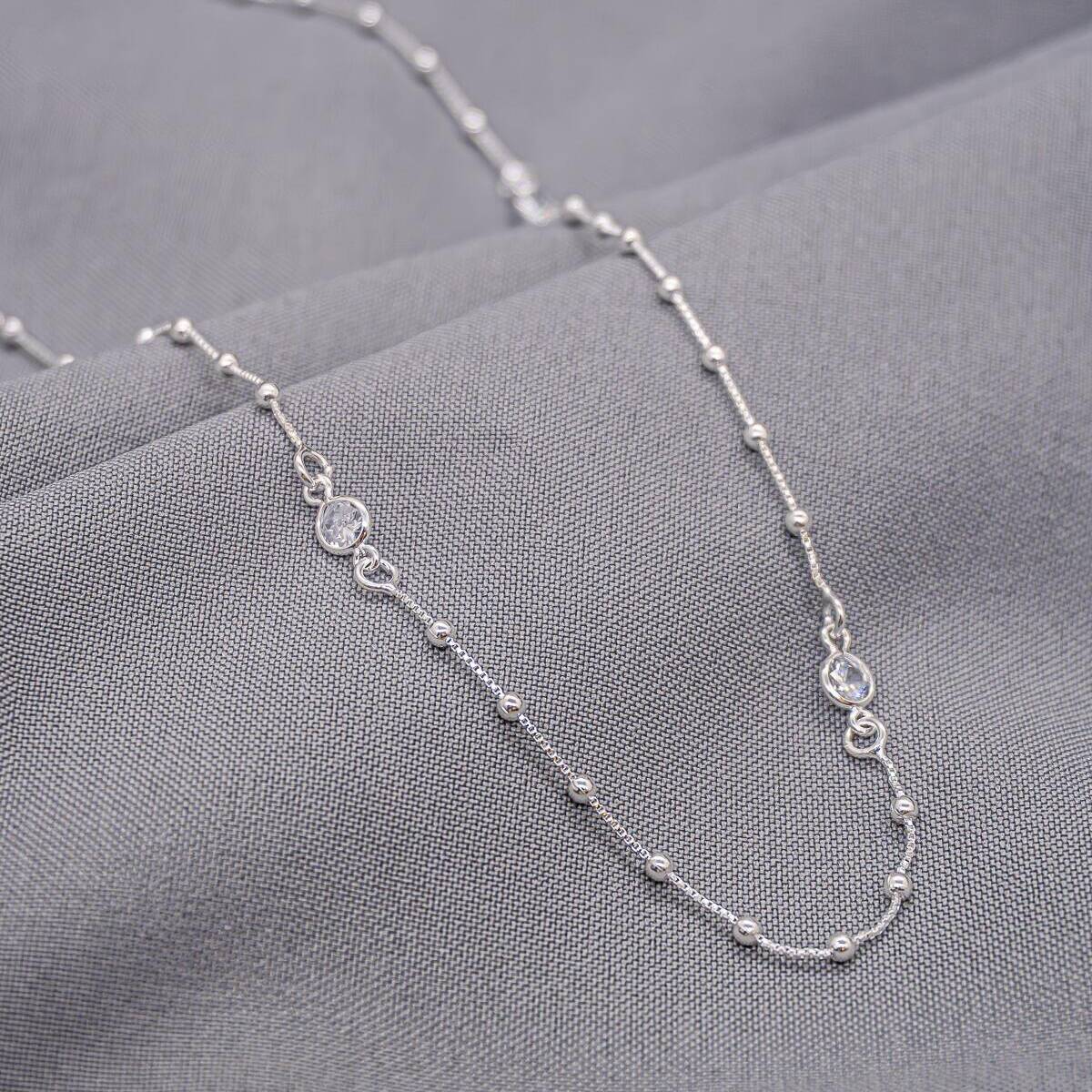Long silver-finish fine chain necklace with tiny beads and two clear stone-set links