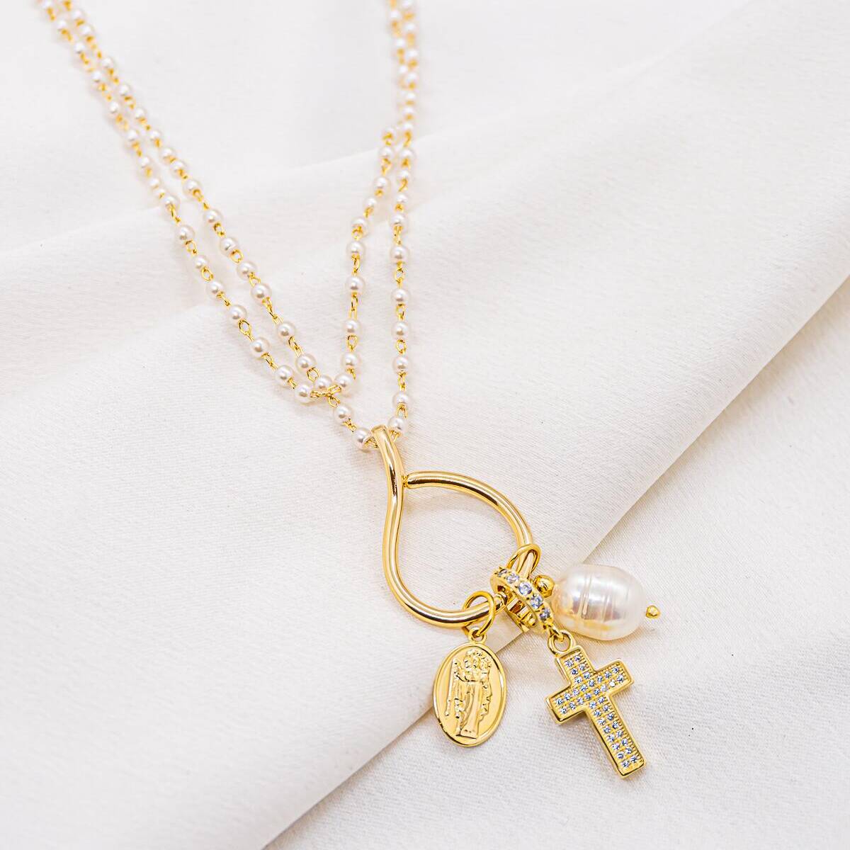 Long necklace with small pearls, open ring with oval medal, pavé-set cross and pearl