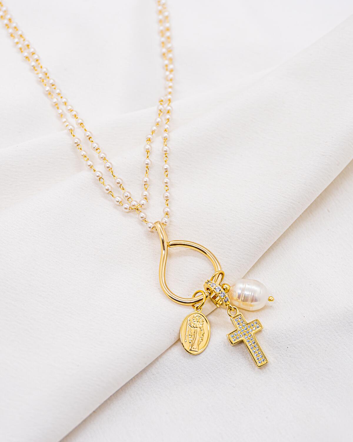Long necklace with small pearls, open ring with oval medal, pavé-set cross and pearl