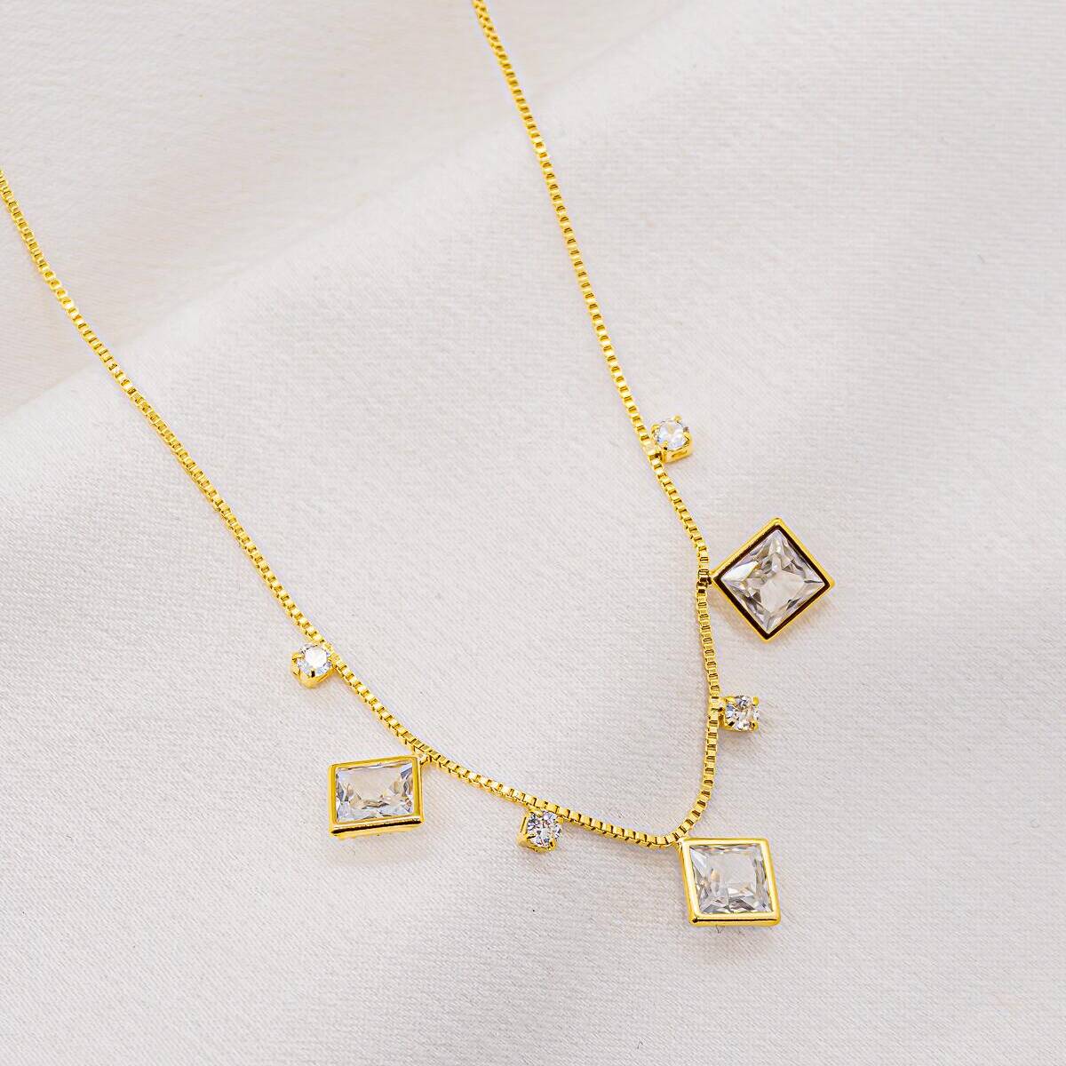 Gold fine box chain necklace with large square zircons and interspersed small round stones
