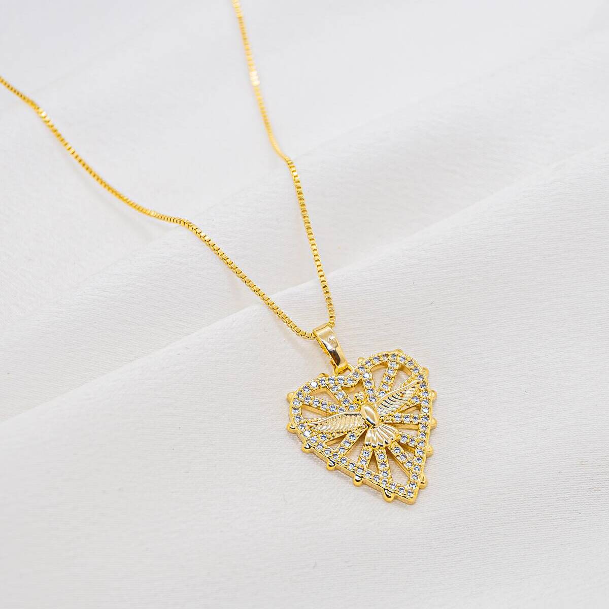 Gold necklace with openwork heart pendant, central dove, and border set with clear stones