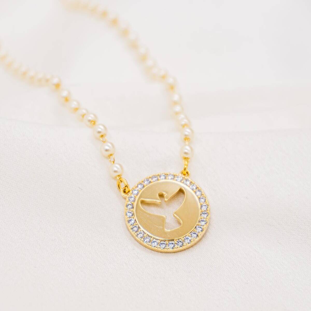 Small White Pearl Necklace with Round Gold Openwork Dove Pendant, Bordered with Clear Stones