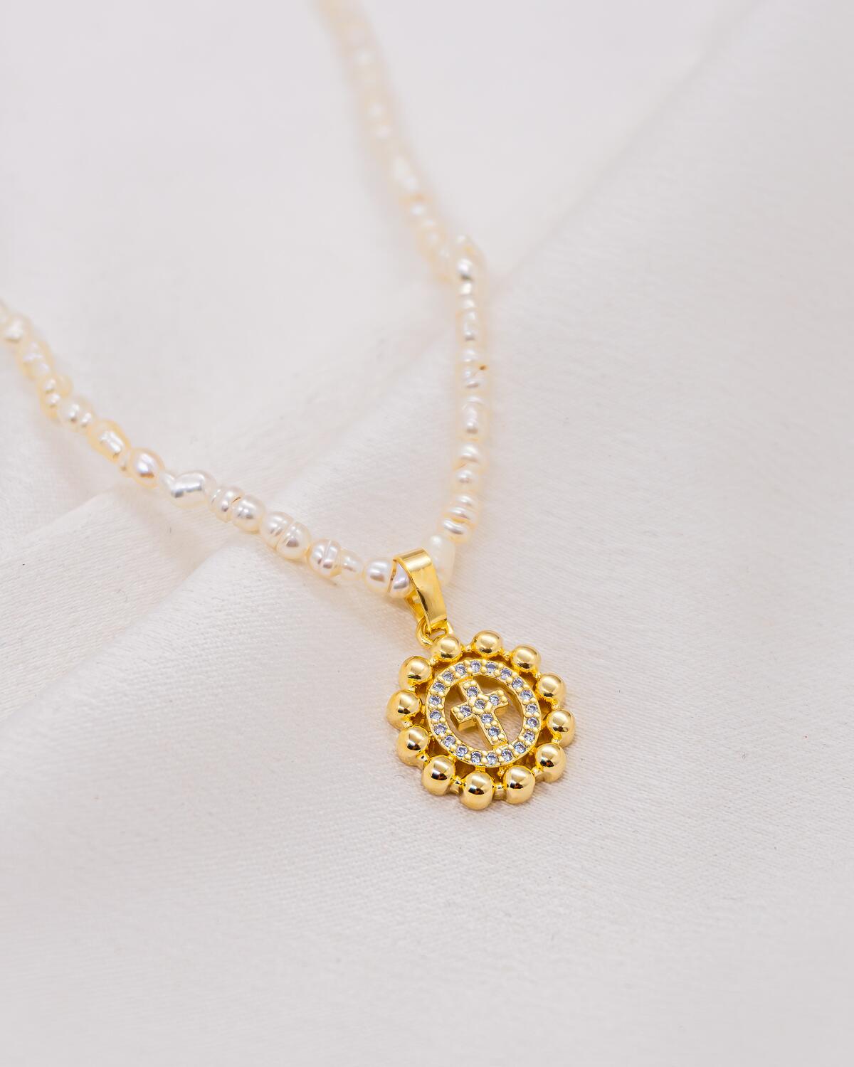 Irregular freshwater pearl choker with small gold round medallion and pavé-set cross in clear stones