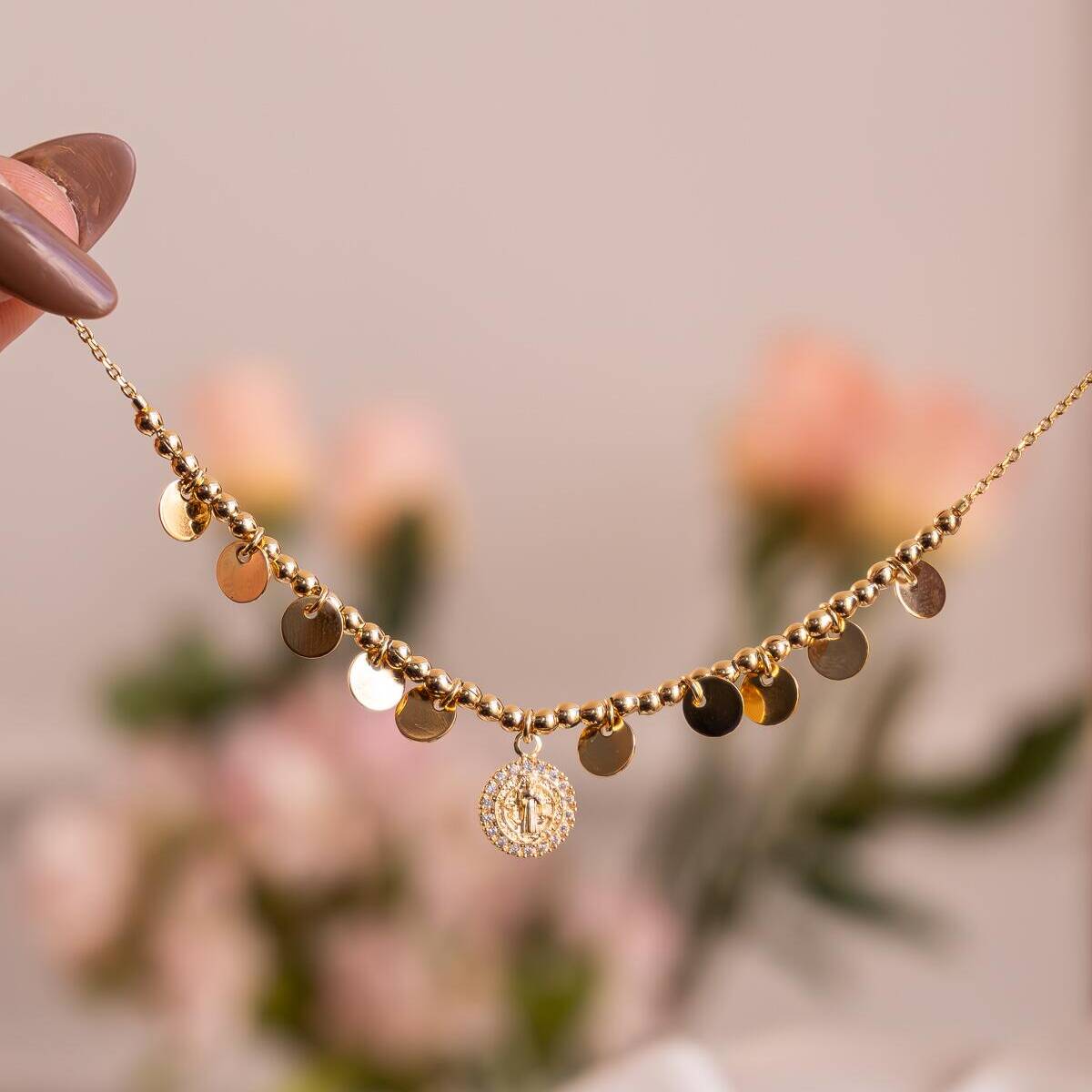 Gold choker with small smooth discs and Saint Benedict medal encircled with stones
