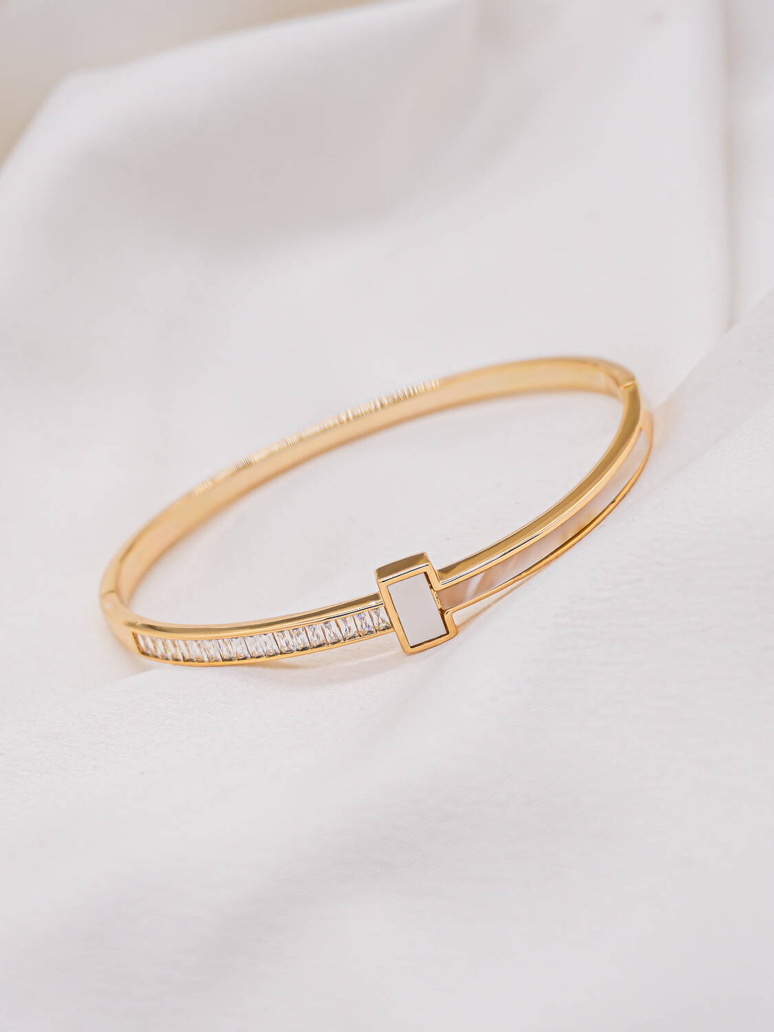 Jonc doré avec rangée de zircons baguette et petit rectangle de nacre central
