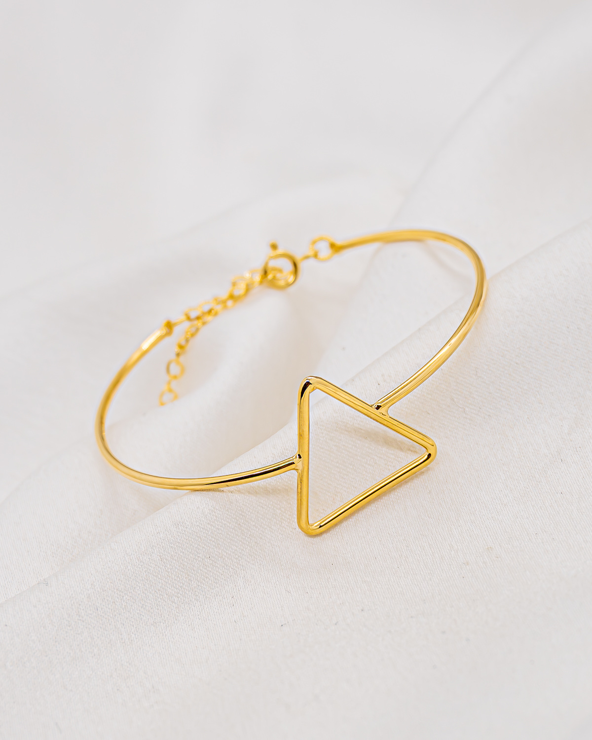 Fine gold openwork triangle bangle with spring ring clasp and extender chain